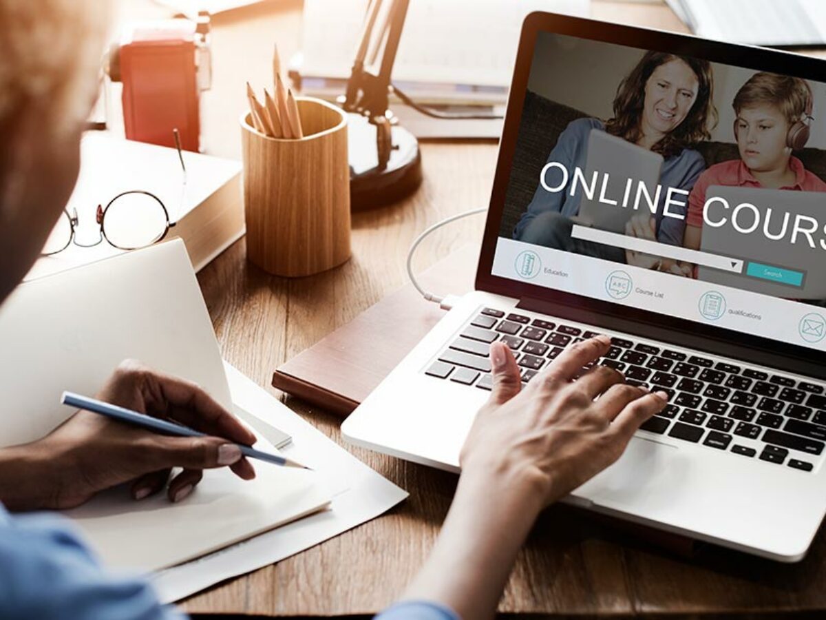 Person using a laptop displaying an online course website
